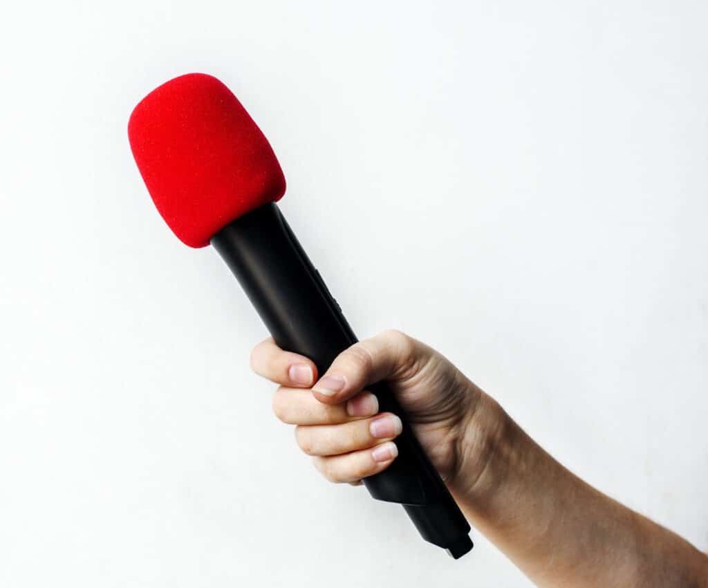 hand holding microphone isolated background 1